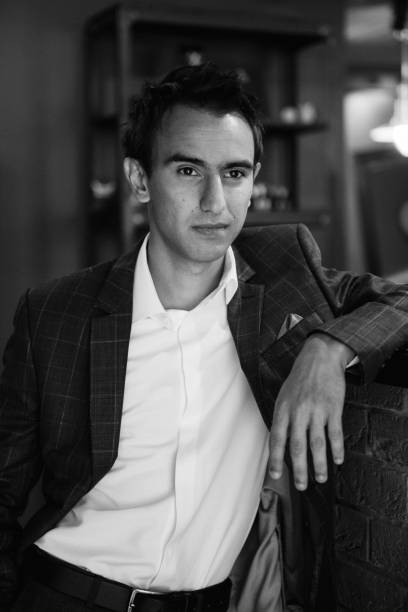 istock Young guy in grey checkered suit in barbershop 2199103909