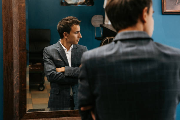 istock Young guy in grey checkered suit in barbershop 2199103940