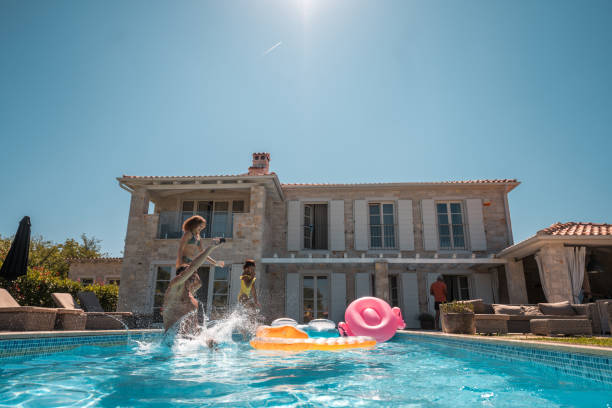 istock Jumping into the Pool with Family 2199106539