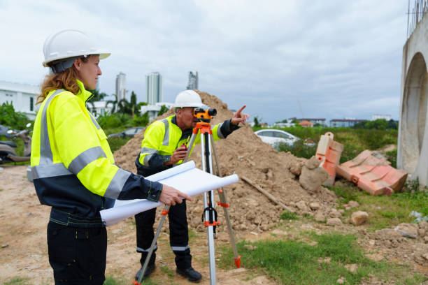 istock Male and female construction engineers discuss and use machines and macros for large construction projects. 2199106970