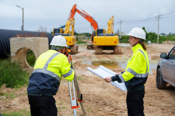 istock Male and female construction engineers discuss and use machines and macros for large construction projects. 2199106971
