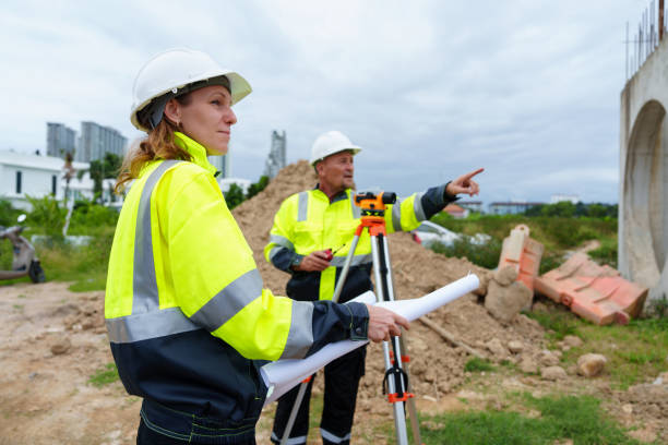 istock Male and female construction engineers discuss and use machines and macros for large construction projects. 2199106972