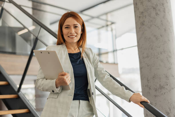 istock Professional Woman Smiling on Office Staircase 2199108883