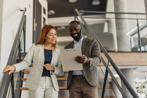 istock Business Partners Laughing on Modern Office Staircase 2199109356