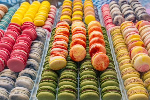 istock Colorful assorted macarons neatly arranged in a pastry shop display 2199109973