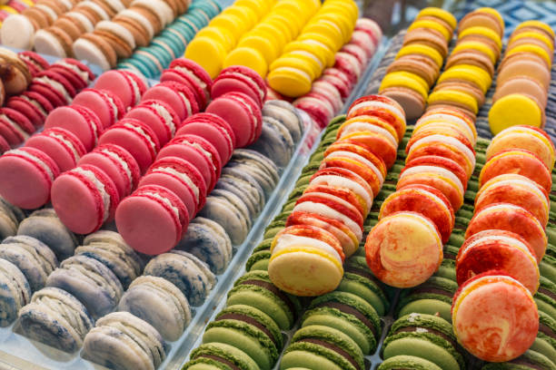 istock Colorful assorted macarons neatly arranged in a pastry shop display. 2199109986