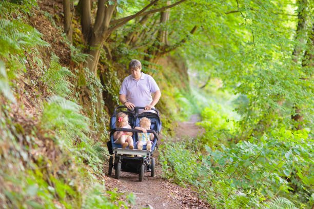 istock Father with children in all terrain stroller 2199111094