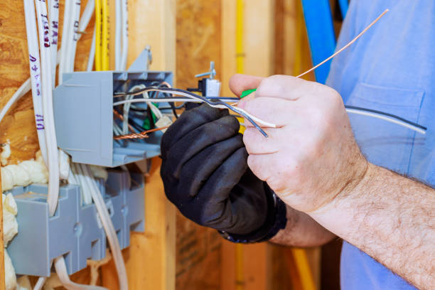 istock Electrician working on wiring installation in a newly constructed home during daylight hours 2199111473