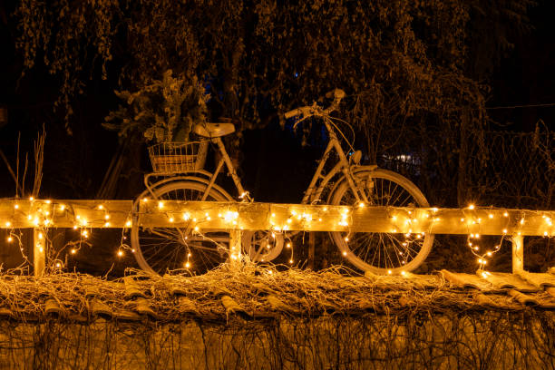 istock Bicycle on a fence with fairy lights 2199111733