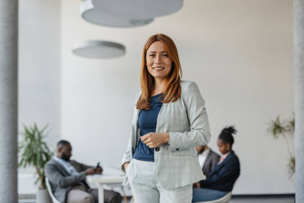 istock Corporate woman standing confidently in office 2199111942