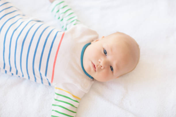 istock Little baby on white bed 2199112072