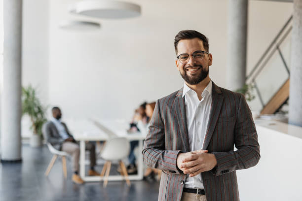 istock Businessman Standing with Arms Crossed, Smiling 2199112316