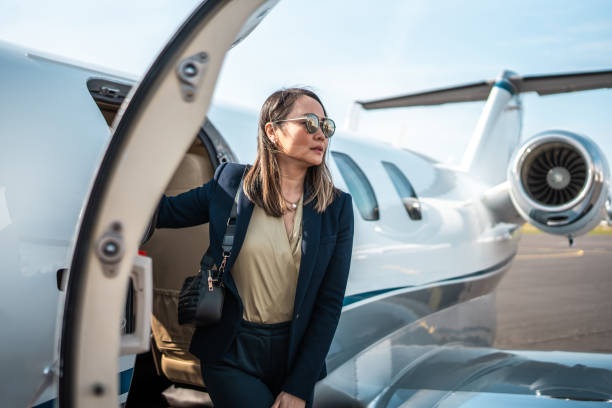 istock Executive Elegance Asian Businesswoman Alighting from Jet 2199112387
