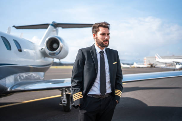 istock Confident Hispanic Male Pilot Beside Private Jet 2199112402