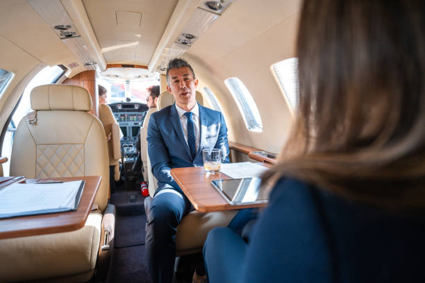 istock Mature Asian Business Executives Discussing in Private Jet 2199112414