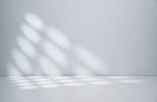 istock Sunlight coming through the window on the white wall 2199113078