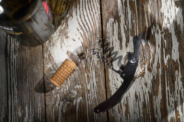 istock Corkscrew and cork resting on rustic wooden table beside a bottle waiting to be opened 2199115924