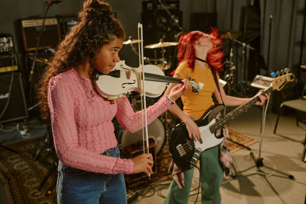 istock Violinist and Guitarist Having Fun Together 2199116140