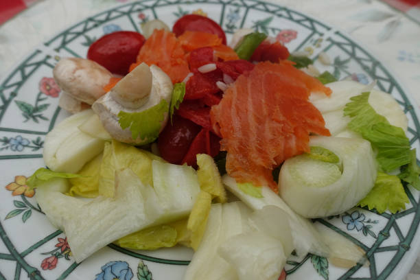 Smoked salmon on mixed salad of raw vegetables  Appetizer buffet
