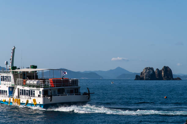 istock tourboat and rock on the sea 2199119312