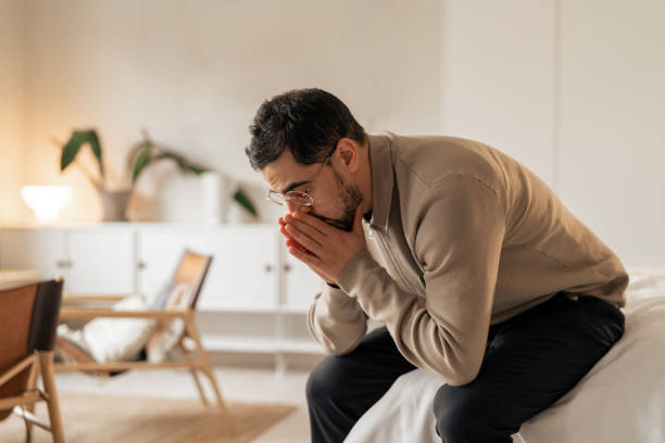istock Thoughtful man sitting indoors in serenity reflecting amid minimalist decor 2199119720