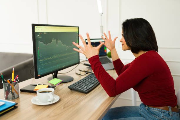 istock Stressed female trader analyzing declining stock market graph, displaying professional tension during remote work session 2199120885
