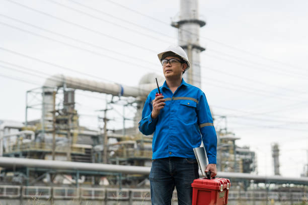 istock Engineers work with walkie talkie in gas refineries and oil refinery plants to check production quality and safety of refineries. 2199122033