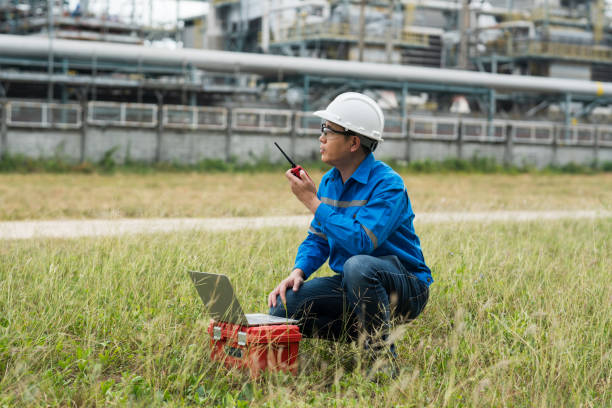 istock Engineers work with walkie talkie in gas refineries and oil refinery plants to check production quality and safety of refineries. 2199122037
