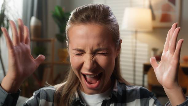 istock Portrait at home problem aggressive panic attack nervous irritated annoyed mad furious stressed Caucasian woman female girl lady bankruptcy divorce yelling shouting screaming rage looking at camera 2199122117