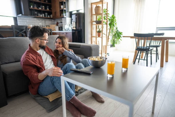 istock Couple watching tv at home 2199122465