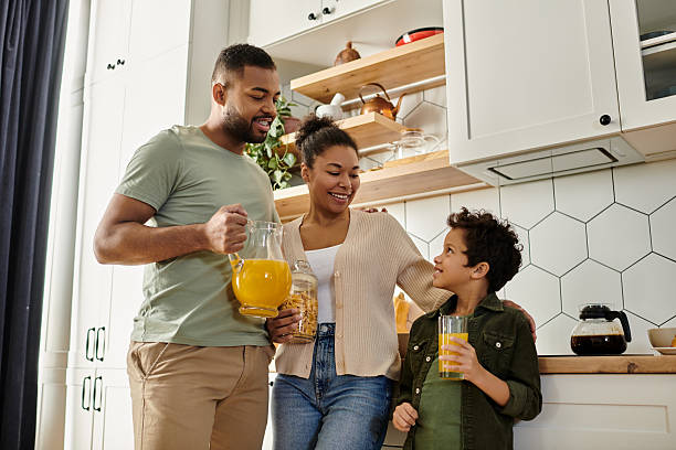istock Family joyfully sharing drinks in a cozy kitchen filled with warmth and love 2199123763