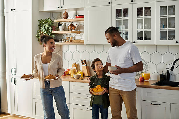 istock Joyful family bonding in a bright kitchen with snacks and laughter 2199123795