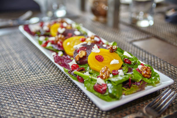 istock Gourmet Beetroot Salad with Goat Cheese and Walnuts on Spinach 2199124119
