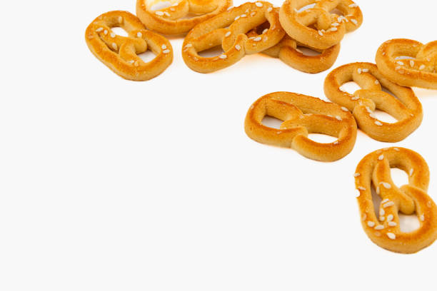 istock Freshly baked pretzels with sesame seeds on a white background 2199124444