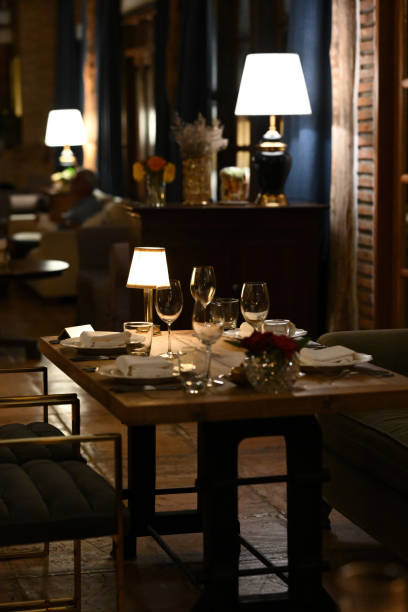 istock Elegant Evening Dining, A cozy dinner setting with warm lighting creates an intimate atmosphere for a romantic evening 2199125400