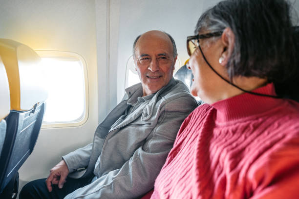 istock Senior Couple Riding In An Airplane 2199125751