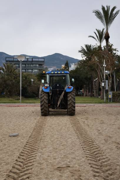 istock tractor on the sea beach 2199125983