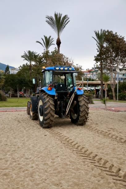 istock tractor on the sea beach 2199126164