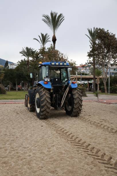 istock tractor on the sea beach 2199126311