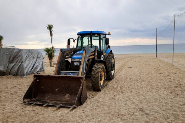 istock tractor on the sea beach 2199126462