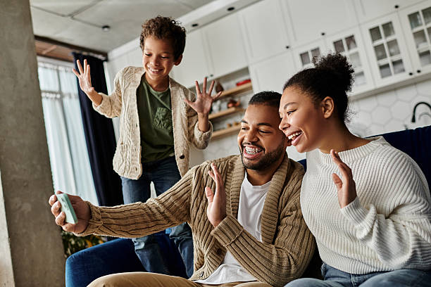 istock Family enjoying quality time together at home while capturing a joyful moment 2199126874