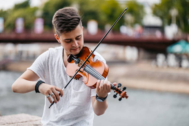 istock Young Man Playing A Violin On The Quayside 2199126886