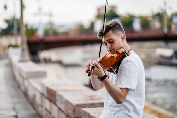istock Young Man Playing A Violin On The Quayside 2199127097