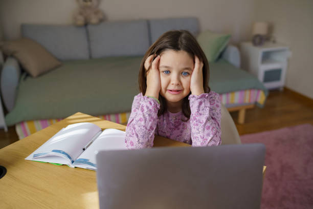 istock Desperate girl doing homework at home 2199127625