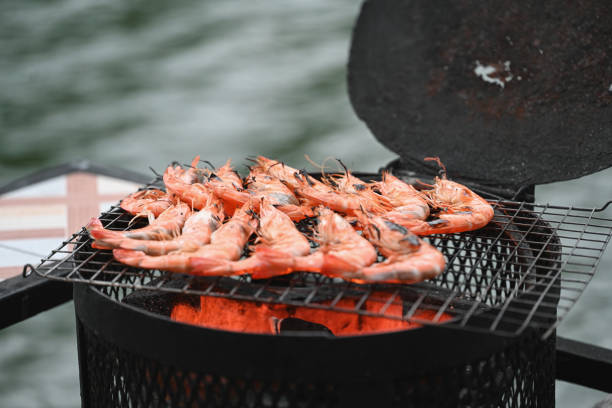 Prawns sizzling on a grill over glowing coals, their shells turning a vibrant orange with charred accents, capturing the essence of a smoky, flavor-packed BBQ experience.