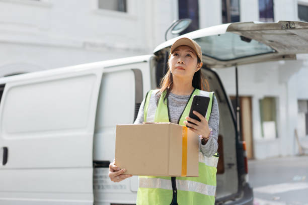 istock Asian delivery woman delivering parcel 2199130207