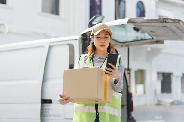 istock Asian delivery woman delivering goods 2199130225