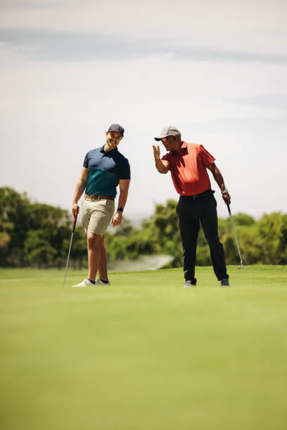 istock Two men strategizing on the golf course, discussing game tactics and wearing golfing attire 2199131797