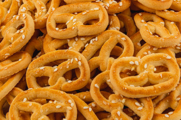 istock Savory pretzels sprinkled with sesame seeds piled high in a warm setting 2199132774