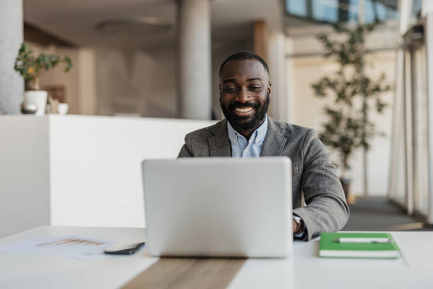 istock Smiling Professional at Laptop in Modern Office 2199132916
